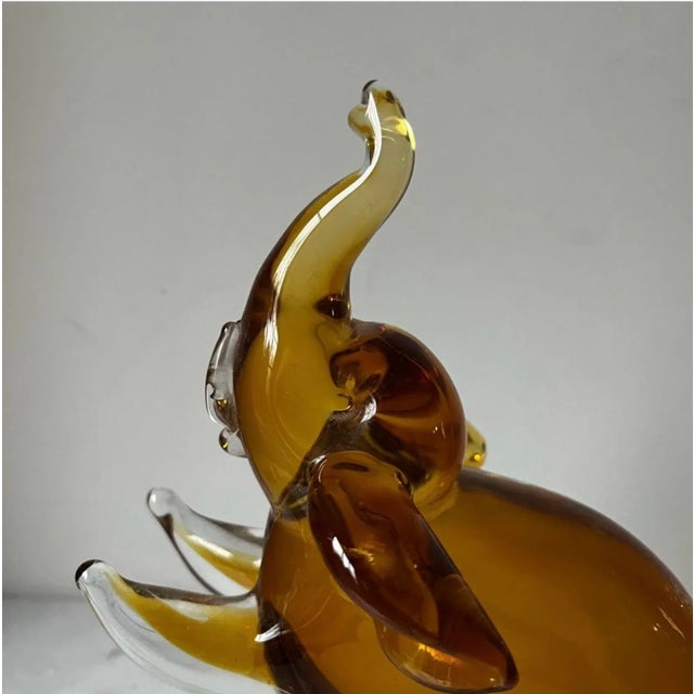 This vintage elephant figurine is a stunning piece of hand-blown art glass from Italy. Standing at 8.5 inches tall and...