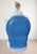 This is a porcelain piece by nao, a company belonging to the lladró group. It depicts a ballerina seated in a blue chair,...