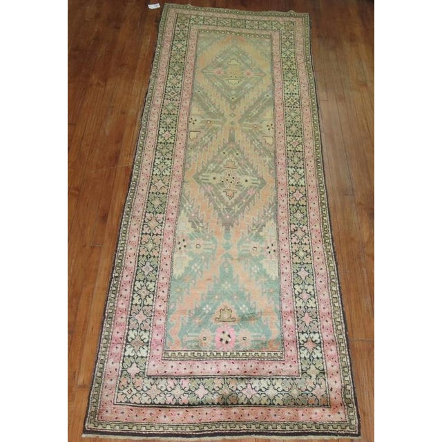A Russian Karabagh runner in funky colors. Predominant accents in lime green and pink. 3'8'' x 10'7''