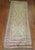 A Russian Karabagh runner in funky colors. Predominant accents in lime green and pink. 3'8'' x 10'7''