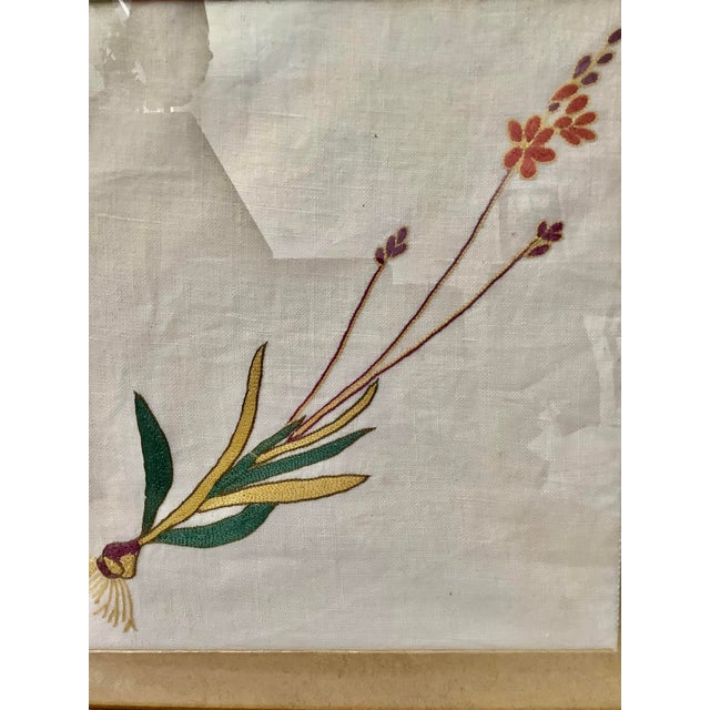 This product is an embroidered floral botanical vintage art piece featuring a linen material with a gold frame, measuring...