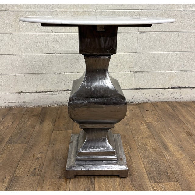 This is a gorgeous metal pedestal table, possibly nickel plated iron, with white marble top. Solid and sturdy, with minor...