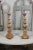 A pair of French Rococo style painted and carved wooden candlesticks from the 19th century, with gilt accents. Created in...