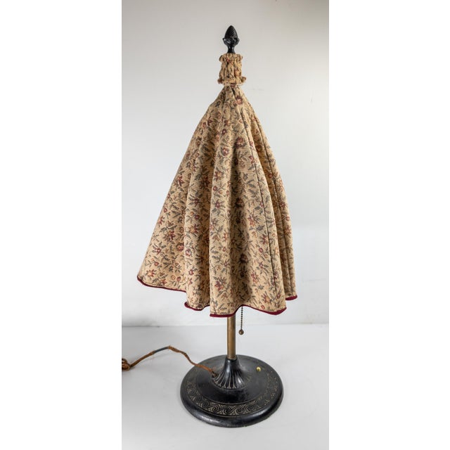 We are selling this cool decorative table lamp. This lamp uses an umbrella mechanism to create the wide textile shade. The...