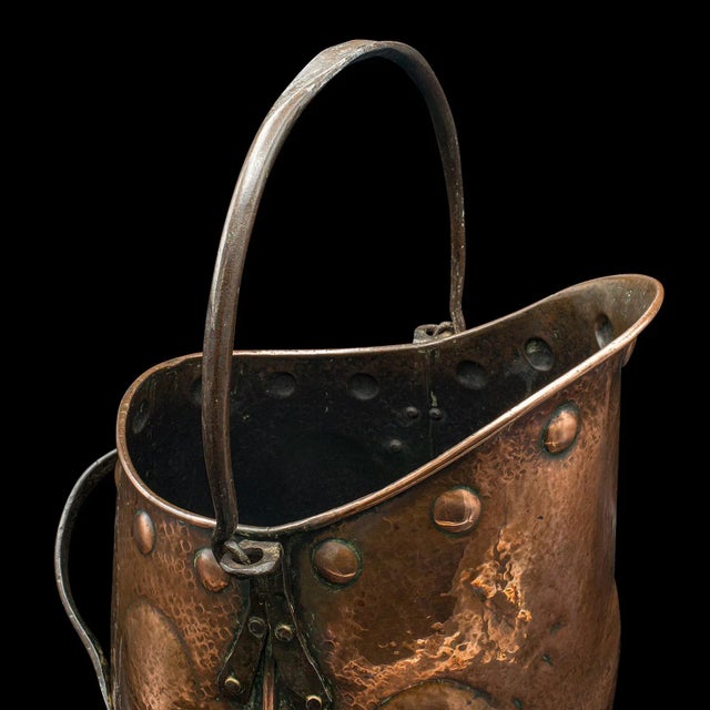 This is an antique coal scuttle. A Scottish, hand-beaten copper fireside bin in Aesthetic Period taste, dating to the...