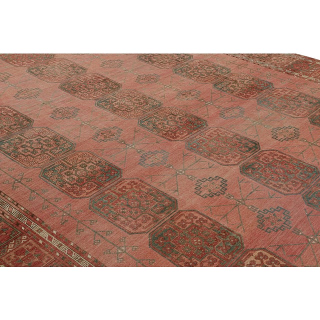 Hand-knotted in wool, originating from Turkey circa 1950-1960, this 10x15 vintage Ersari rug is from the same provenance,...