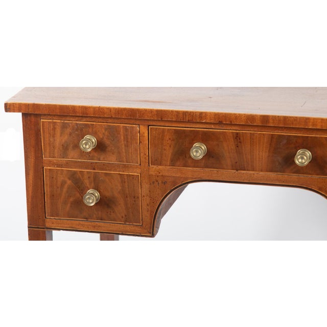 Antique English Ladies Writing Desk With a center drawer flanked by four short drawers with arched form kneehole supported...