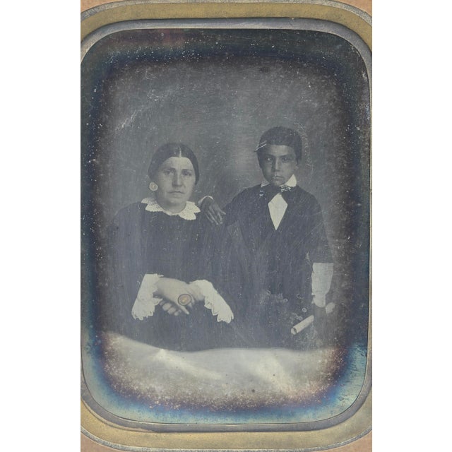 Double portrait, silver plate presented under glass, with a cream paper mat, a gilt border, and a silver outline in its...