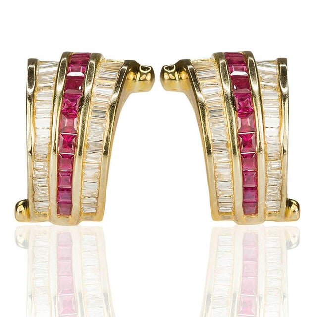 14k Earrings containing 20 square rubies weighing approximately 1.50 carats and 80 bagutte diamonds weighing approximately...