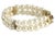 Double-strand faux-pearl bracelet interspersed with three spacer bars set with five rhinestones each. The goldtone metal...