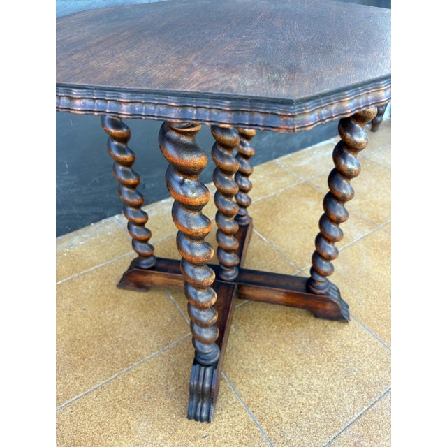 Elegant octagonal side table crafted in solid wood, featuring five richly carved barley twist legs united by a cross-...