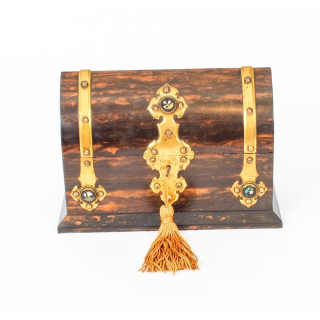 This is an antique Victorian Coromandel scent bottle box of domed form with elaborate decorative brass mounts with inset...