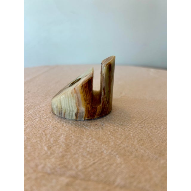 A beautiful stone piece that not only holds a pen and paper but triples as a paper weight also.