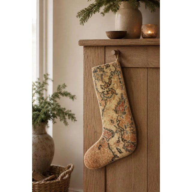 Hand-cut from a genuine vintage Turkish wool kilim, this stocking pairs a warm terracotta toe with a cream leg carrying a...