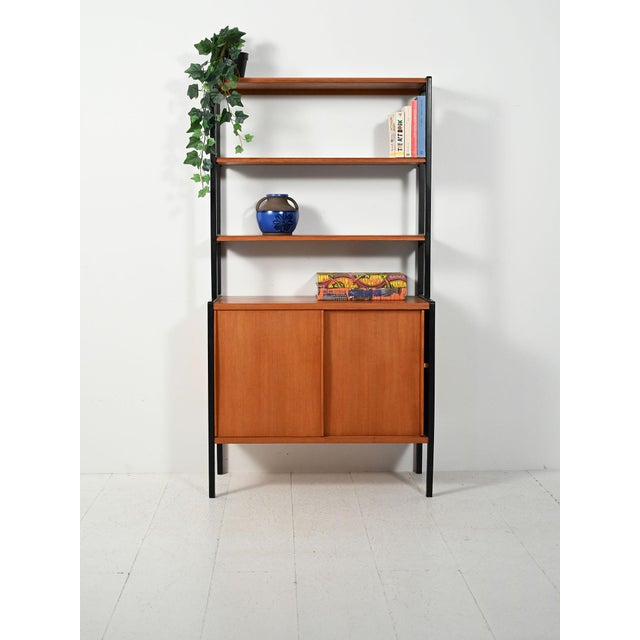 "Variett" teak bookcase with contrasting black uprights, designed by Bertil Fridhagen for Bodafors, Sweden. The "Variett"...