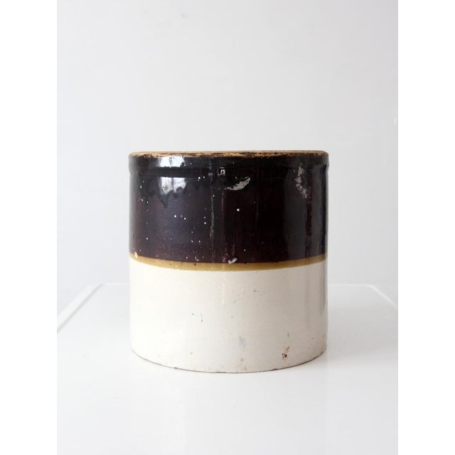 Antique Western Stoneware 4-gallon crock featuring a brown glazed shoulder, cream stoneware body, and cobalt “4” gallon...