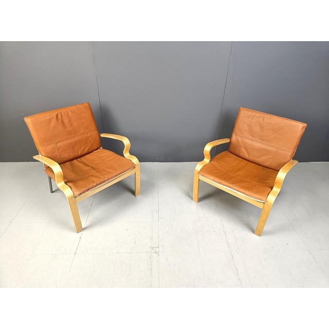 Pair of bentwood plywood armchairs with leather cushions designed by Johan Huldt for Ikea model 'Bjärred'. Beautiful curvy...