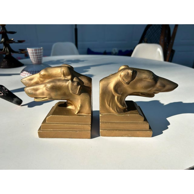 Greyhound Bookends by Nuart Creations, [ca. around 1930’s]. Weighted pot metal with a warm gold finish. Both stamped "©...
