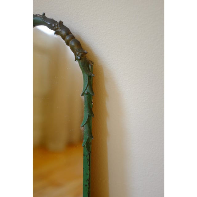 Circa 1950s Swedish Modern Green painted Wall Mirror with sculptured organic details around the frame and a woman depicted...