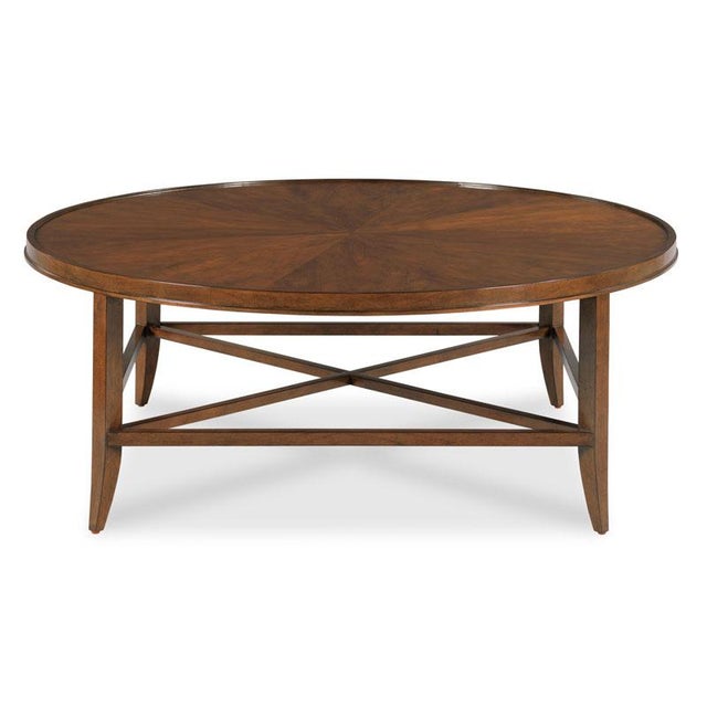 This circular coffee table embodies classic elegance with its traditional design and rich cherry veneer. It seamlessly...