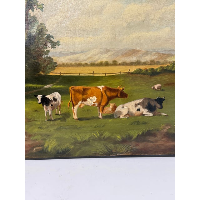 An unsigned 19th-century pastoral oil on canvas, probably English, depicting cattle and sheep at rest within an open rural...
