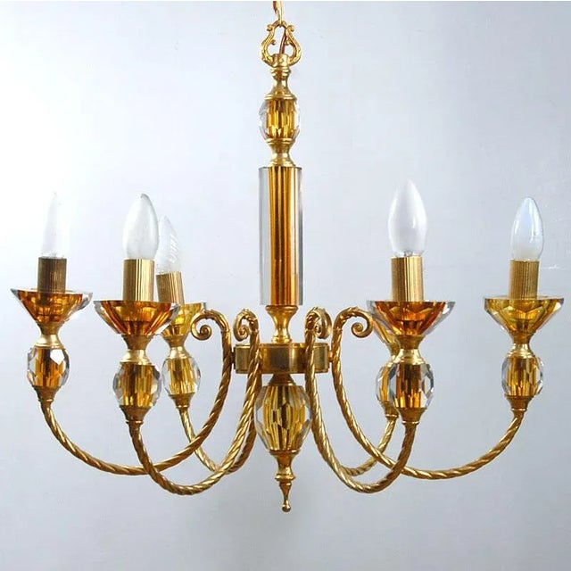 An impressive chandelier made of gilded metal. Decorative elements are made of sanded plane, Sommerso crystal glass. He...