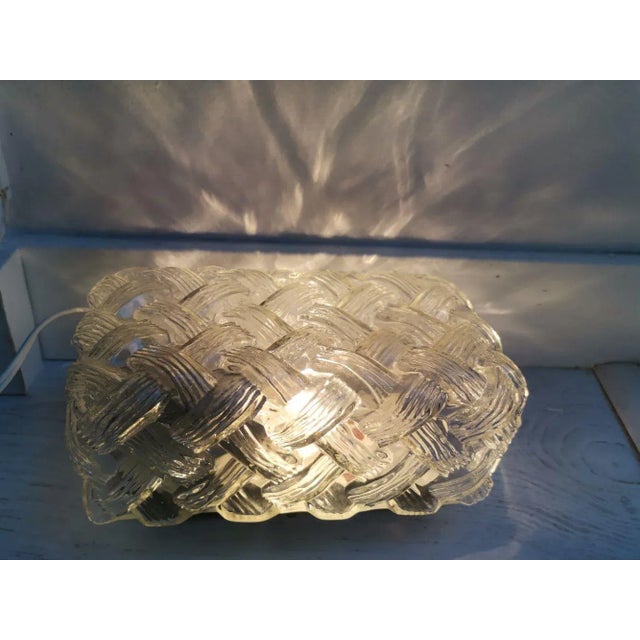 Vintage 70s-80s flush mount lamp, made in textured clear glass and painted black aluminium base. Can be mounted on the...