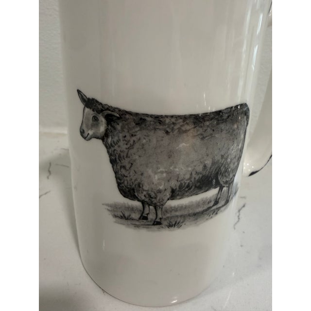 Vintage White Jug / Pitcher With a Sheep on Both Sides With Black Trim From England This jug / pitcher was made in...