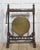 A striking late 19th-century Gothic Revival freestanding gong, mounted in an elaborately carved walnut frame of...