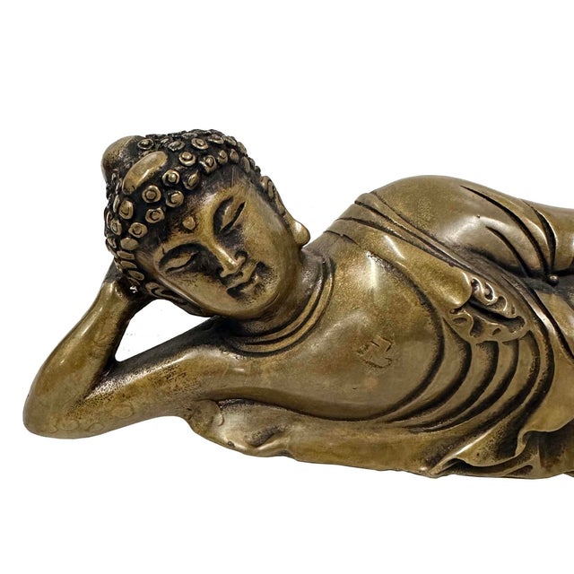 This image depicts a Reclining Buddha statue, a significant iconographic representation in Buddhist art. The reclining...