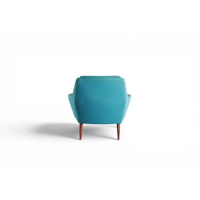 This 1960s Danish low-back lounge chair pairs a sculpted teak frame with its original blue wool upholstery, capturing the...