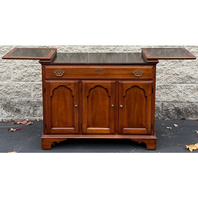 Beautiful cherry flip top server by Statton. The server features classic Chippendale style with 3 door and 1 drawer...