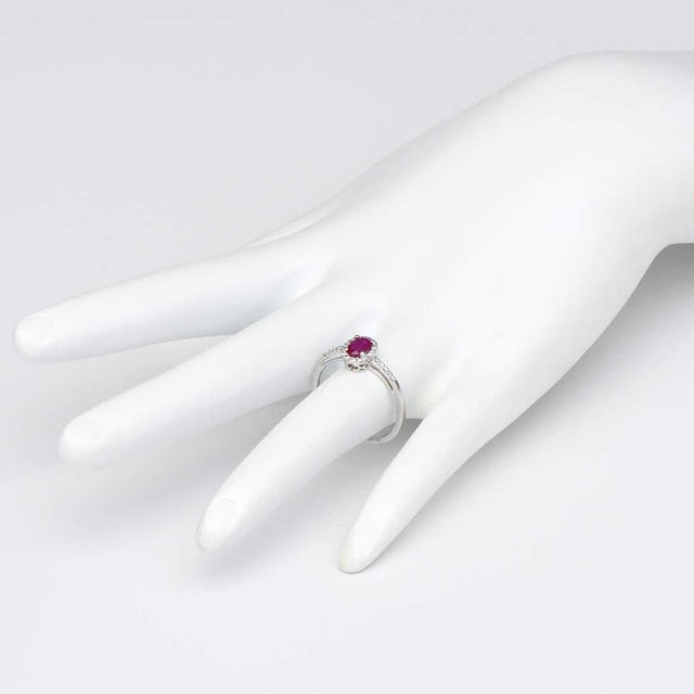 Set in 14-karat white gold, this ruby & diamond halo style ring is perfect for the woman who loves to stand out. Featuring...