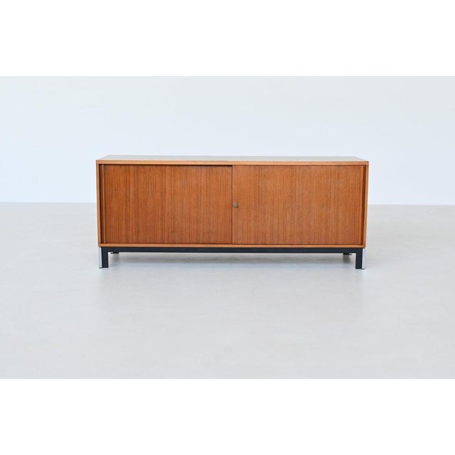 Beautiful sideboard designed by Theo Tempelman for AP Originals, The Netherlands 1960. This symmetric sideboard is a...