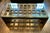 This is a large substantial Theodore Alexander coffee table with a thick beveled glass top on a sculptural gridwork wood...
