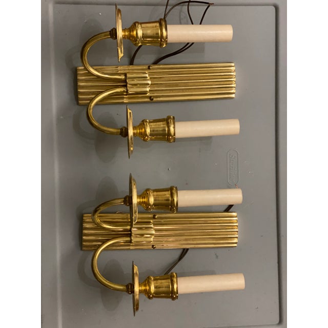 A pair of circa 1920’s gilt bronze double light sconces