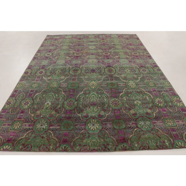 This 9x12 contemporary European-inspired rug, hand-knotted in wool and natural silk, celebrates richly ornamented floral...