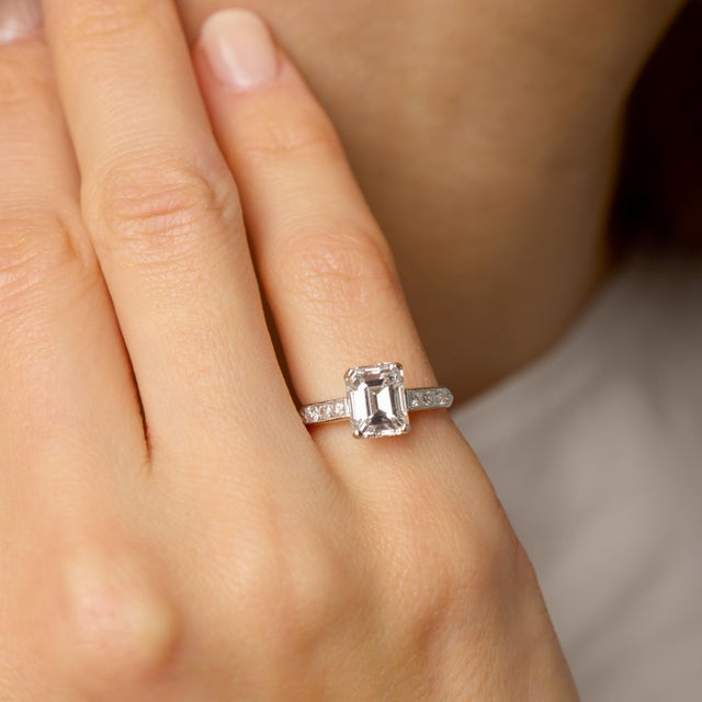 This striking Mid Century engagement ring showcases the quiet power of an exceptional emerald cut diamond. The center...