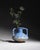 A French art pottery vase with angular twin handles and a flowing blue-grey crystalline glaze. The elongated amphora form...