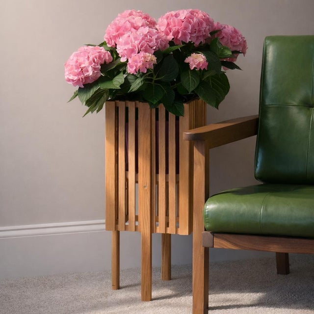 Slatted solid wood floor planter — a vertical, architectural object for the home. The clean slatted frame creates shadow...