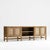 This is a light brown Credenza with rattan doors. Composed of Teak and Teak veneer. The photos make it appear worn,...