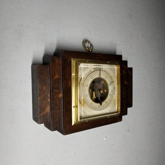Beautiful antique barometer made of wood, metal, brass, and thick beveled glass. Brass bezel and dial background Texts in...