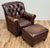 Classic vintage tufted wingback chair upholstered in a warm brown leather. Features deep button tufting on the backrest...