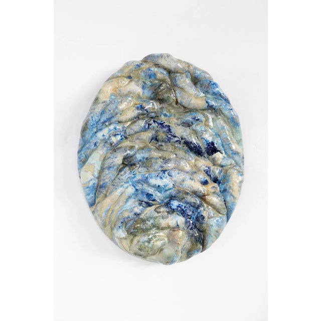 Oval blue wall sculpture by Natasja Alers, 2022 Dimensions: 40 x 7 x 30 cm Material: ceramics Visual artist Natasja Alers...