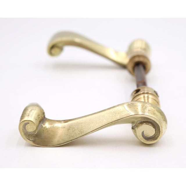 Modern style polished brass lever handles with a swirl shape. Good condition with surface wear from prior use. Priced as a...