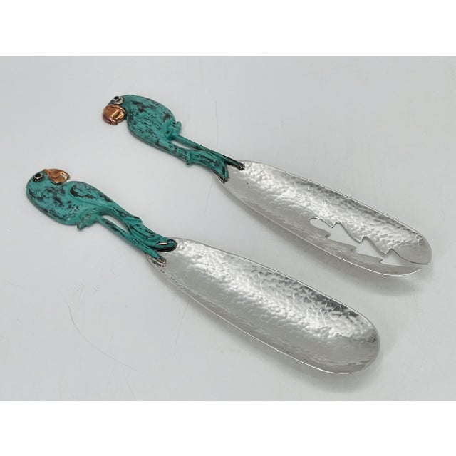 An exceptional and increasingly scarce pair of Emilia Castillo serving utensils, handcrafted in Taxco, Mexico, showcasing...
