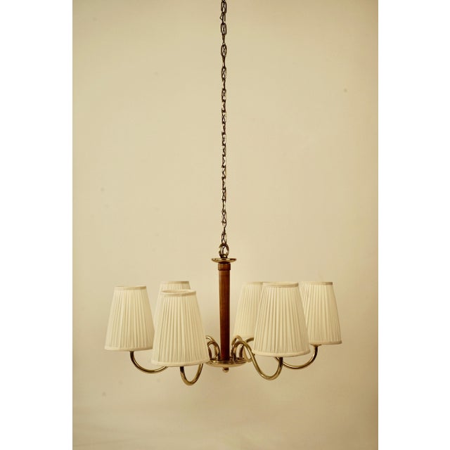 A beautiful six arm brass chandilier designed by oswald haerdtl in the 1930's. The the brass has been completely restored....