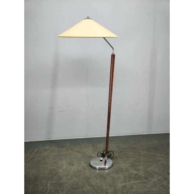An elegant mid-century modern floor lamp produced by zukov in czechoslovakia during the 1960s, beautifully combining...