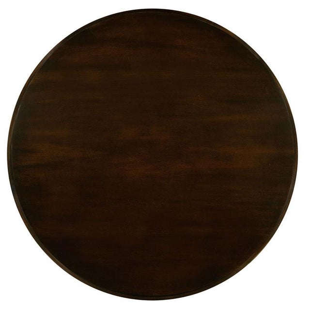 A round mahogany veneered top is elevated by elegant tapering saber legs joined by an "X" stretcher.