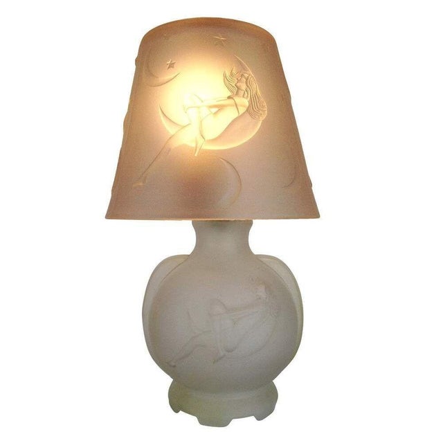 Re-edition frosted glass boudoir lamps, each known as the "Lay by the Stars," features a nude woman gazing at the stars...